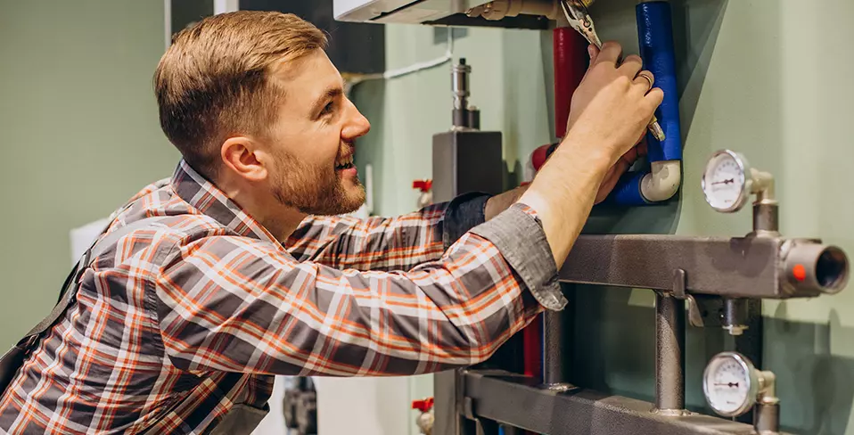 plumber-in-uniform-choosing-water-heating-radiator-2021-08-27-09-31-15-utc